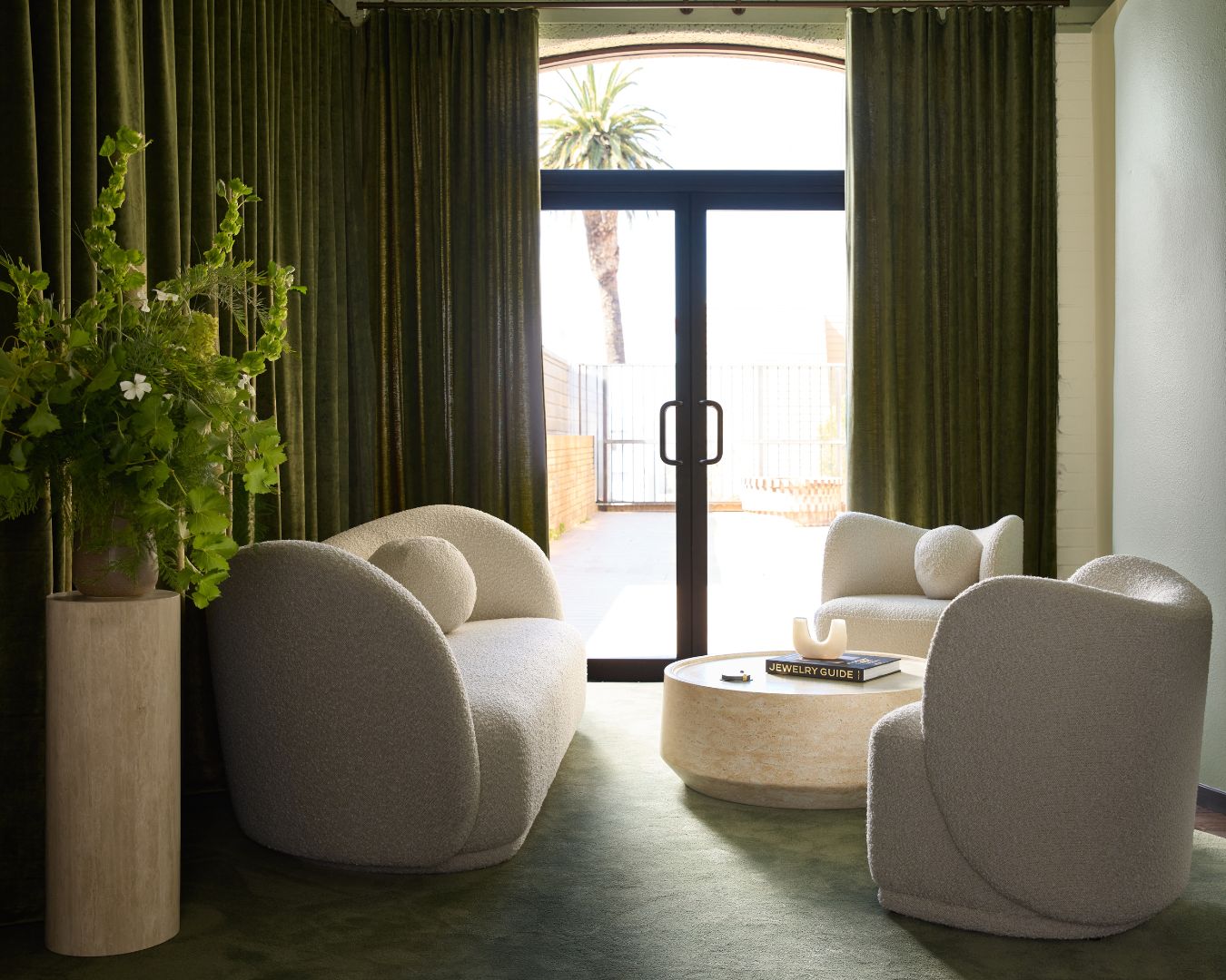 Cullen Jewellery lounge seating area with green curtains and natural light